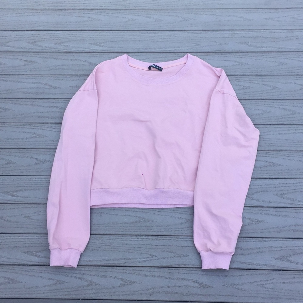 Light pink cropped shirt.